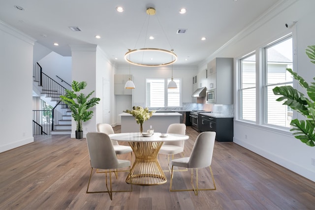 dining room featuring dark hardwood / wood-style floors and ornamental molding