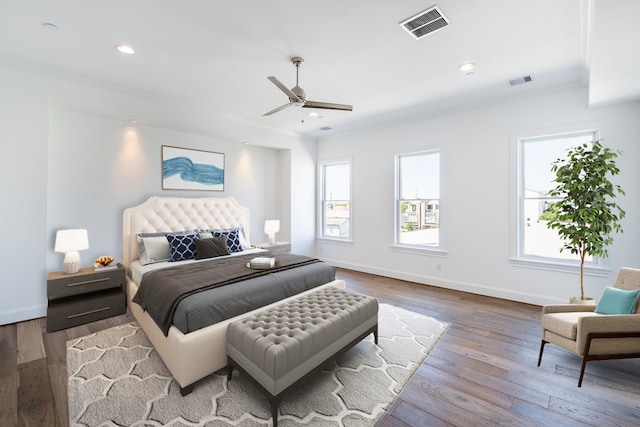 bedroom featuring wood-type flooring, ceiling fan, and crown molding