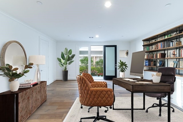 office featuring light hardwood / wood-style floors and crown molding