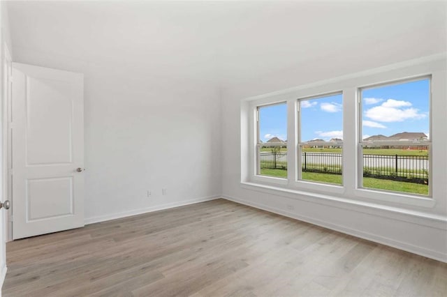 spare room featuring light wood-type flooring