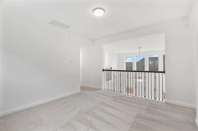 empty room with light colored carpet