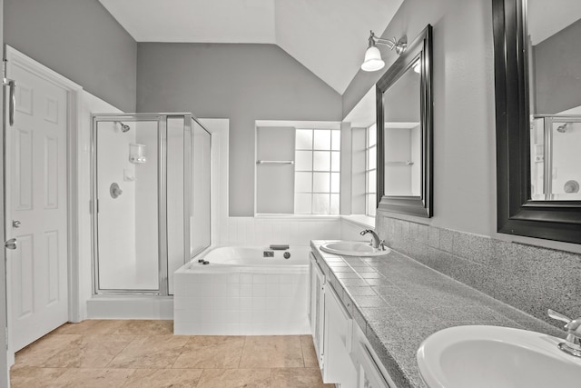 bathroom with lofted ceiling, separate shower and tub, and vanity