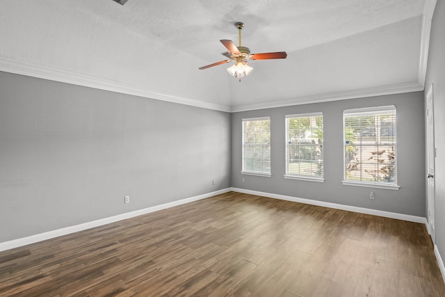 empty room featuring wood-type flooring, vaulted ceiling, a textured ceiling, ornamental molding, and ceiling fan