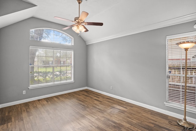 empty room featuring dark wood-type flooring, ceiling fan, lofted ceiling, and ornamental molding