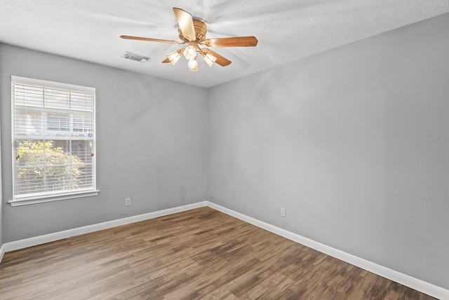 empty room with hardwood / wood-style floors, ceiling fan, and a textured ceiling