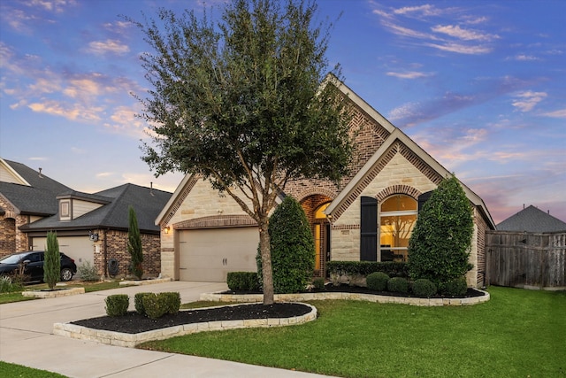 view of front of house with a garage and a lawn