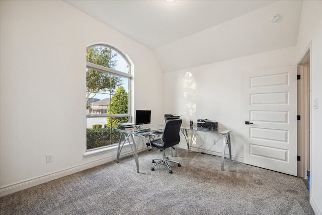 carpeted office featuring lofted ceiling