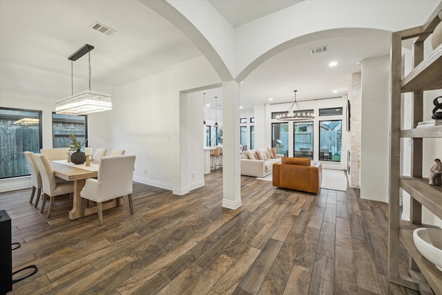 dining room featuring dark hardwood / wood-style flooring and an inviting chandelier