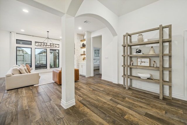 interior space featuring a chandelier and dark hardwood / wood-style floors