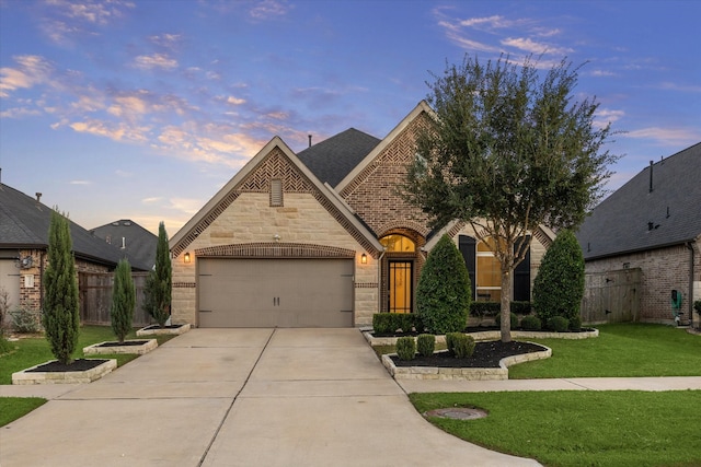 view of front of house featuring a garage and a yard