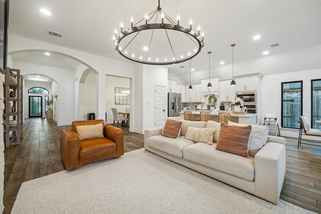 living room featuring wood-type flooring and a notable chandelier