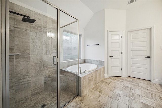 bathroom featuring plus walk in shower and lofted ceiling