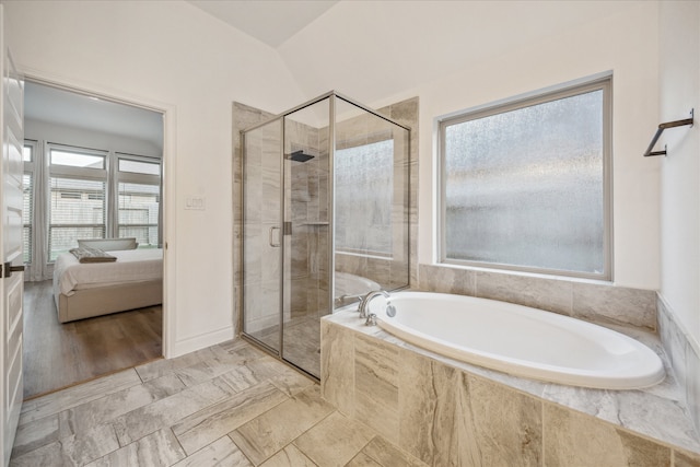 bathroom featuring plus walk in shower and lofted ceiling