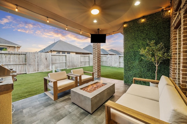 view of patio featuring an outdoor living space with a fire pit