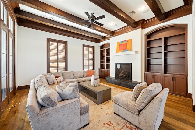 living room featuring french doors, ceiling fan, beam ceiling, built in features, and hardwood / wood-style floors