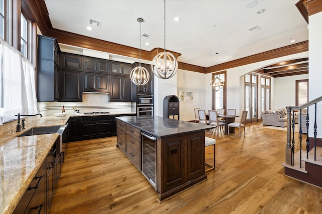 kitchen with wine cooler, a kitchen island, and a healthy amount of sunlight