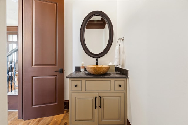 bathroom with hardwood / wood-style floors and vanity