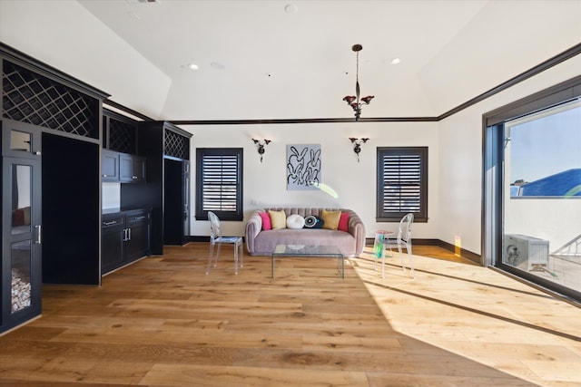 living area with hardwood / wood-style floors and high vaulted ceiling