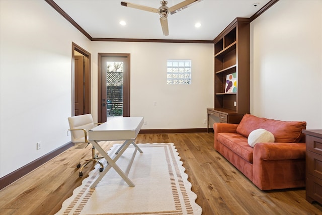 home office featuring light hardwood / wood-style flooring, ceiling fan, and ornamental molding