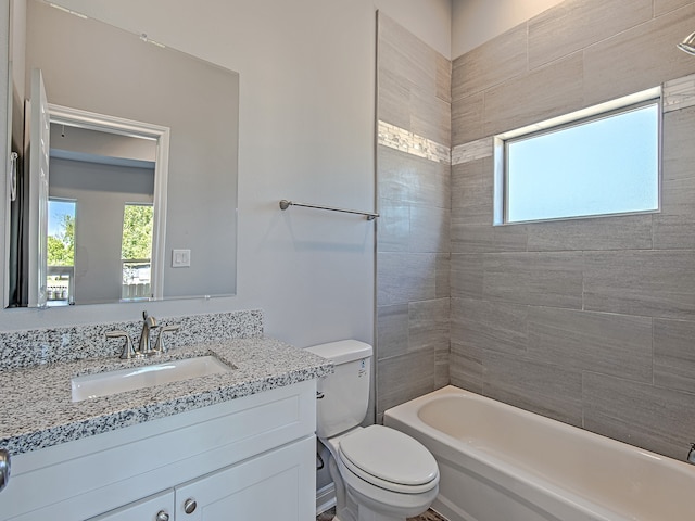 full bathroom featuring vanity, toilet, and tiled shower / bath