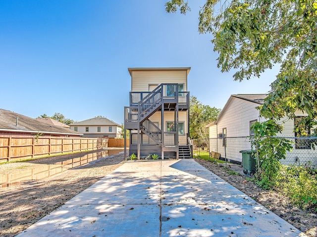 back of property featuring a wooden deck