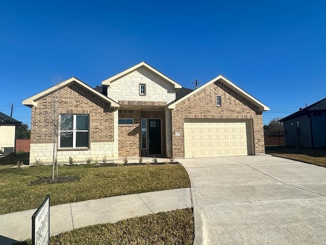 view of front of property with a garage and a front lawn