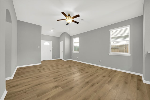 spare room featuring lofted ceiling, ceiling fan, and light hardwood / wood-style flooring