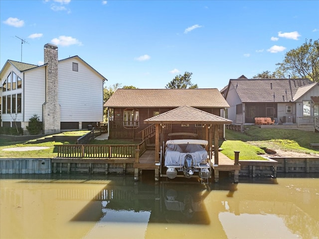 dock area featuring a water view and a lawn