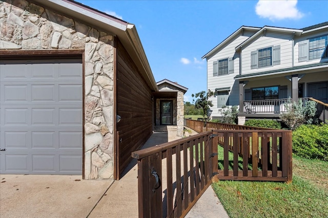 doorway to property featuring a garage and covered porch