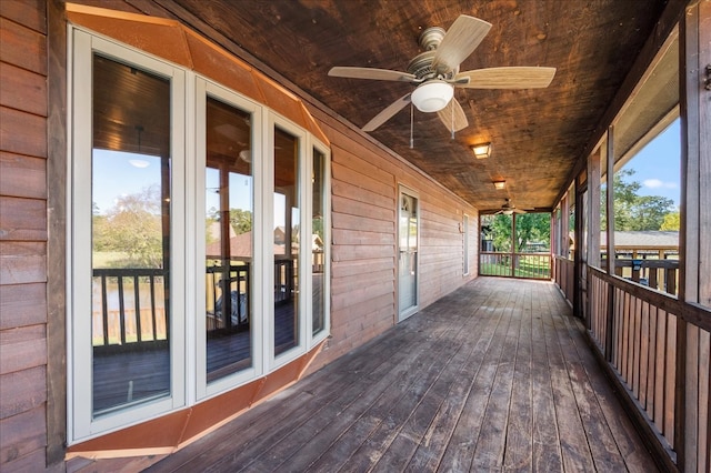 wooden terrace featuring ceiling fan and french doors