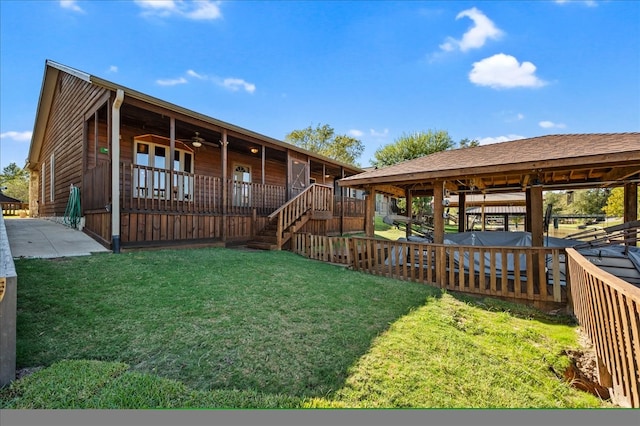 exterior space featuring a wooden deck and ceiling fan