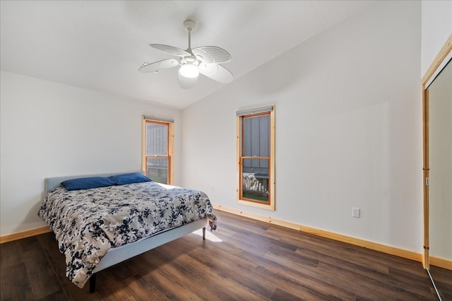 bedroom with dark wood-type flooring, a closet, vaulted ceiling, and ceiling fan