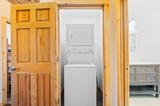 laundry area featuring stacked washer and clothes dryer