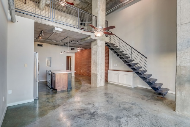 garage with ceiling fan and stainless steel fridge