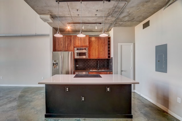 kitchen with electric panel, a kitchen island, appliances with stainless steel finishes, hanging light fixtures, and sink