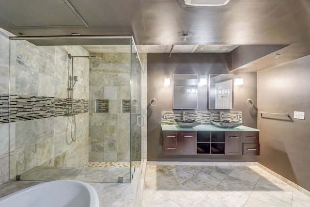 bathroom with backsplash, vanity, and separate shower and tub