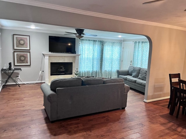 living room featuring ornamental molding, wood-type flooring, and ceiling fan