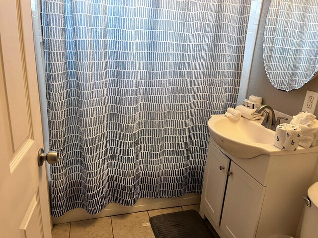 bathroom with toilet, vanity, and a shower with shower curtain