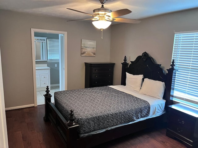 bedroom with dark wood-type flooring, connected bathroom, and ceiling fan