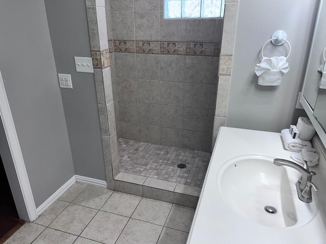 bathroom with sink, tile patterned floors, and tiled shower