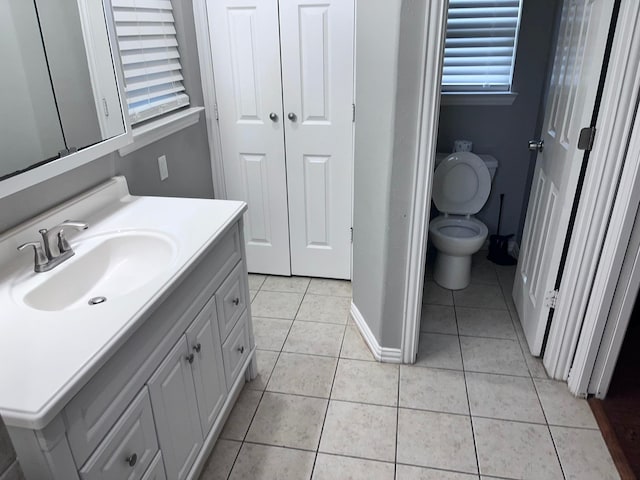 bathroom featuring vanity, tile patterned flooring, and toilet