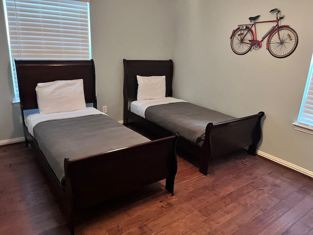 bedroom with dark hardwood / wood-style flooring