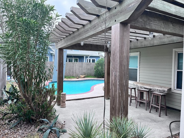 view of swimming pool with a patio and a pergola