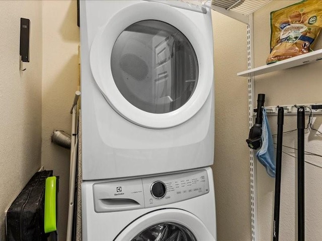 laundry room featuring stacked washing maching and dryer