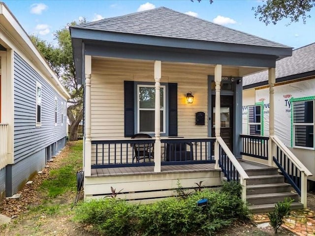 rear view of house with a porch