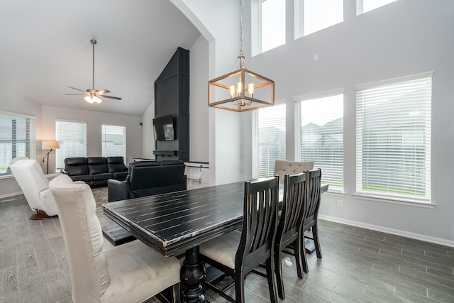 dining room with ceiling fan with notable chandelier and lofted ceiling