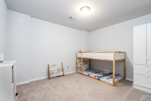 carpeted bedroom with a textured ceiling