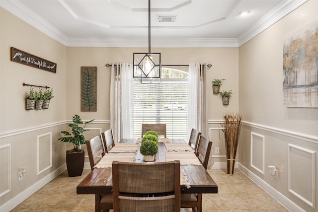 dining area featuring light tile patterned flooring, a raised ceiling, crown molding, and a chandelier