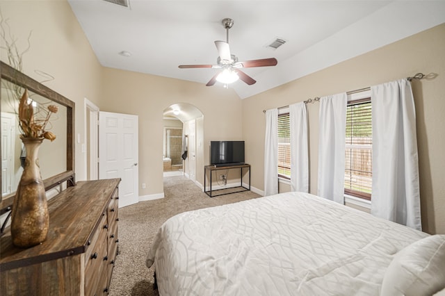 bedroom featuring light colored carpet, vaulted ceiling, and ceiling fan