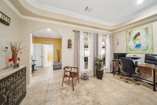 tiled office space with ornamental molding and a tray ceiling